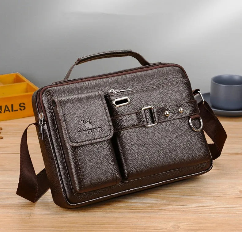 A dark brown men's PU leather crossbody shoulder bag with a flap and strap resting on a wooden surface.