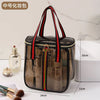 A clear waterproof travel toiletry bag with black and red straps, showing various grooming products inside.