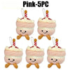 Five pink bread plush keychains with white frosting and striped straws