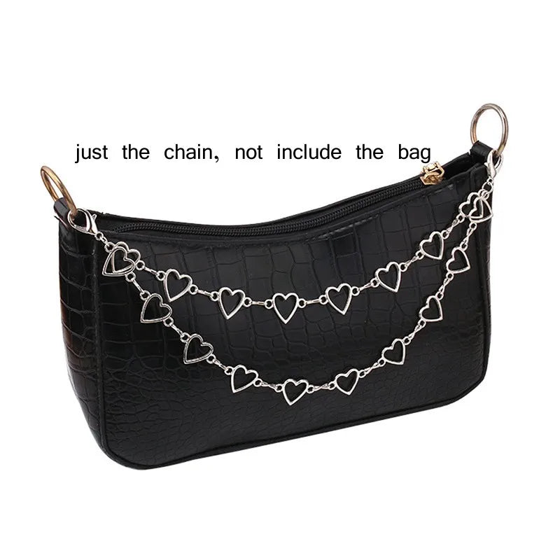 Black faux leather bag featuring a multi-layer silver chain strap with heart pendants