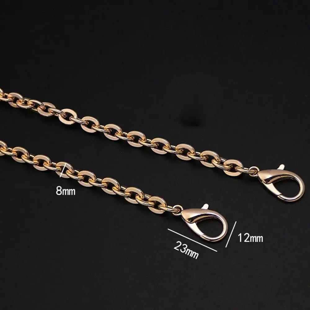 Gold-toned metal chain strap with adjustable links and oval clasps shown against a black background.