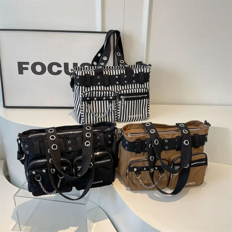 A display of three chains and rivet nylon shoulder bags in black, white, and brown tones.