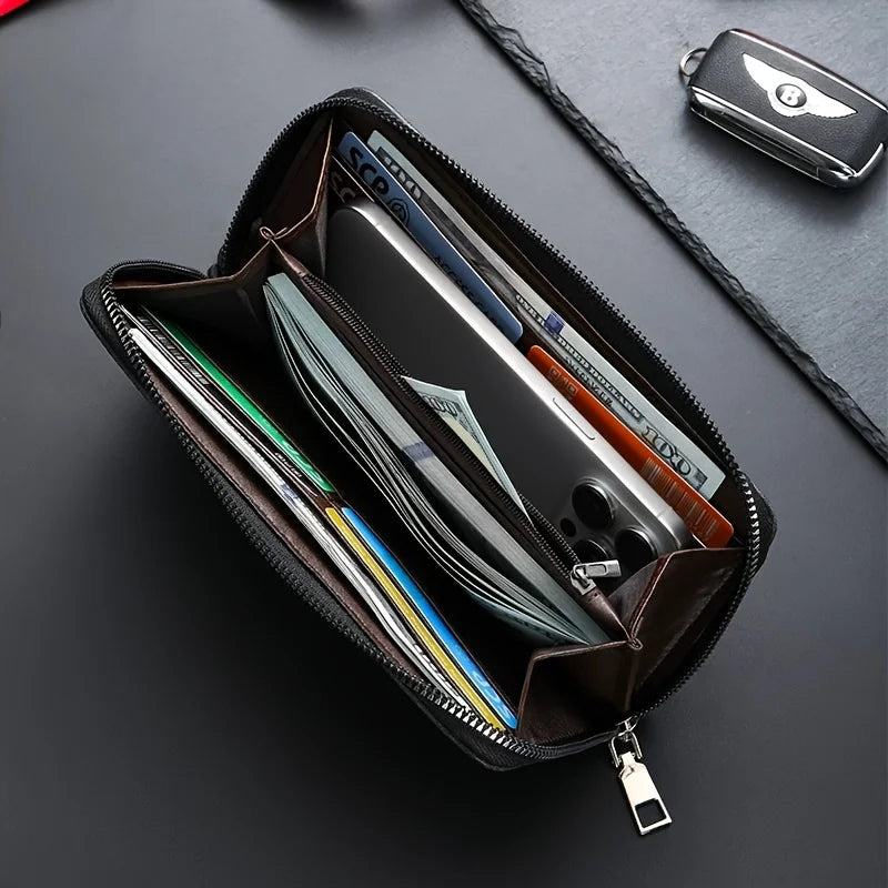 A dark brown leather wallet with multiple card slots is shown open on a black surface, next to a small black accessory.