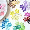 A collection of colorful vintage star hair clips and barrettes in various shades of pink, purple, yellow, blue, and green.