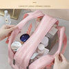 A pink double-layer clear and dry wash bag is shown open, displaying various toiletries inside.