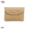 A tan genuine leather card holder or coin purse with a visible stitching detail and a round brass-colored closure.