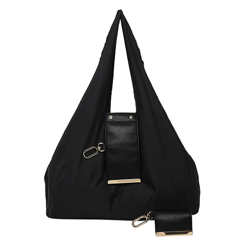 Black stylish cloth storage pouch with gold hardware and a leather strap attached.