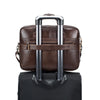 A brown genuine cowhide leather briefcase bag with silver handles and a black carrying case.