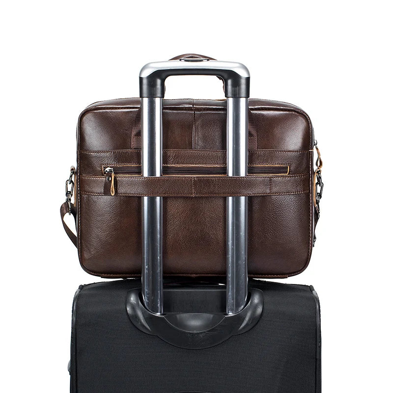 A brown genuine cowhide leather briefcase bag with silver handles and a black carrying case.