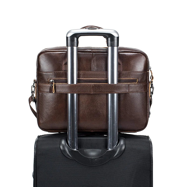 A brown genuine cowhide leather briefcase bag with silver handles and a black carrying case.