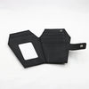 Black leather wallet with a vintage embossed design and a cutout for cards.