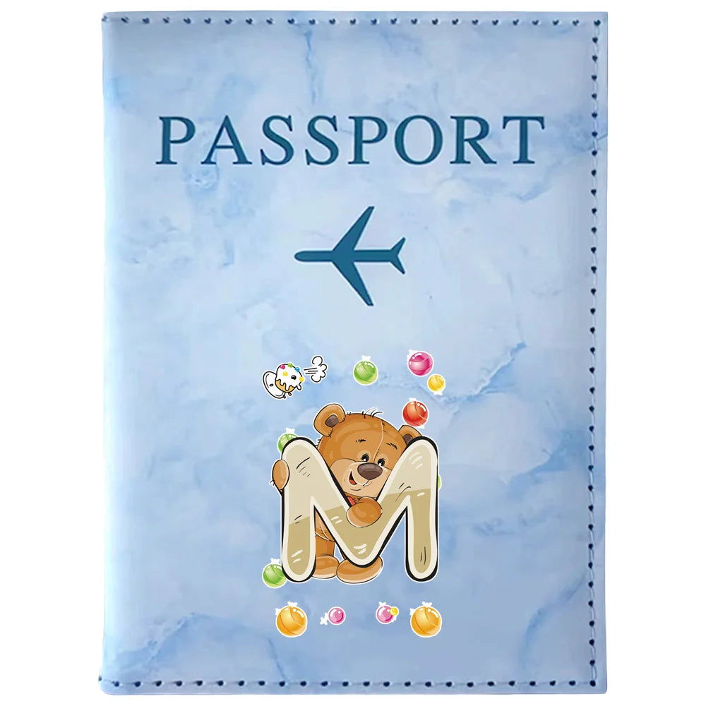 Light blue passport card holder featuring a large letter M and a small airplane graphic