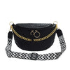 A black woven pattern waist bag with a gold chain strap is displayed against a white background.