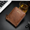 A brown leather wallet with gold stitching rests on a dark surface next to a glass of amber liquid.