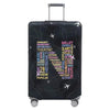 A black suitcase with a transparent stretch fabric protection cover featuring various performance and arts-related words.