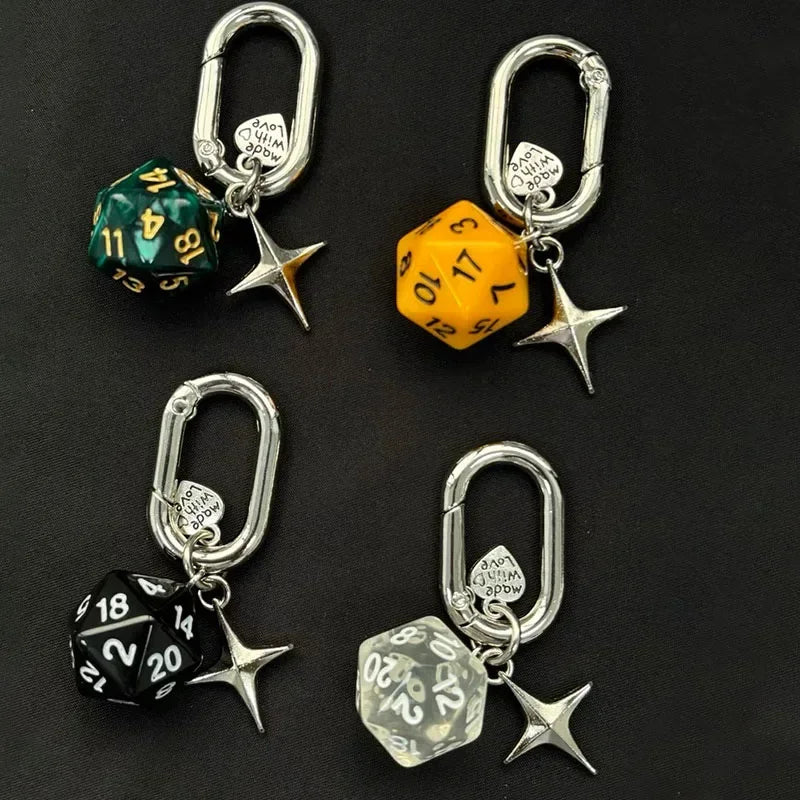A set of resin dice keychains featuring green, yellow, and black dice designs on silver metal split rings.