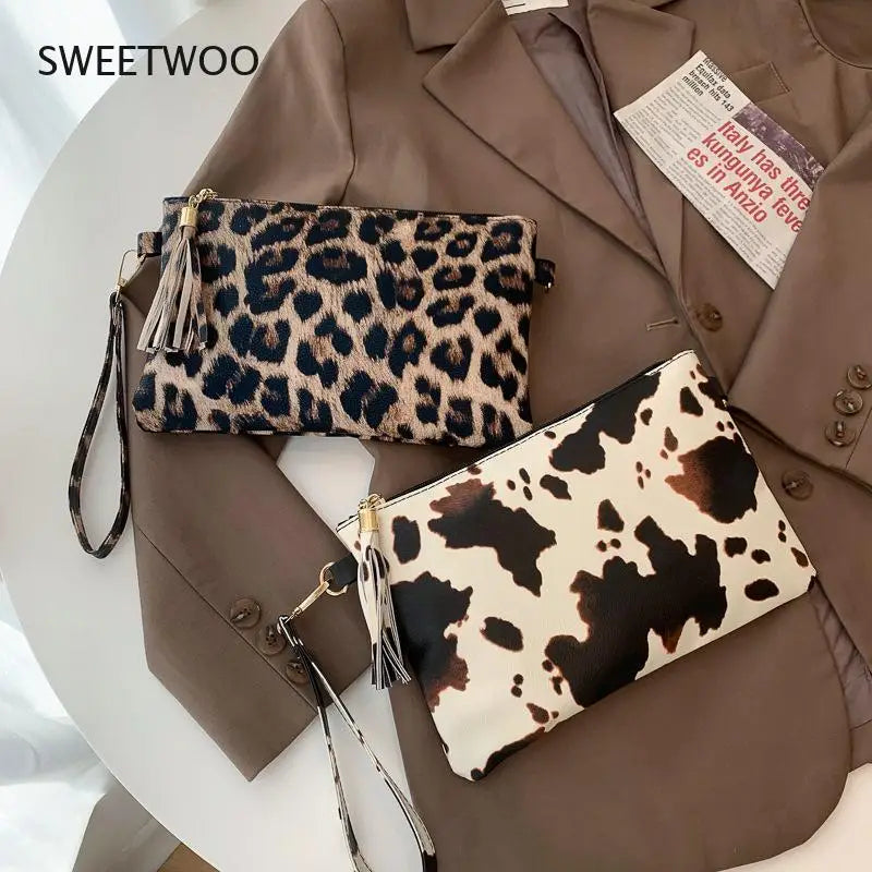 A brown blazer features two leopard print faux leather wrist bags with tassels.