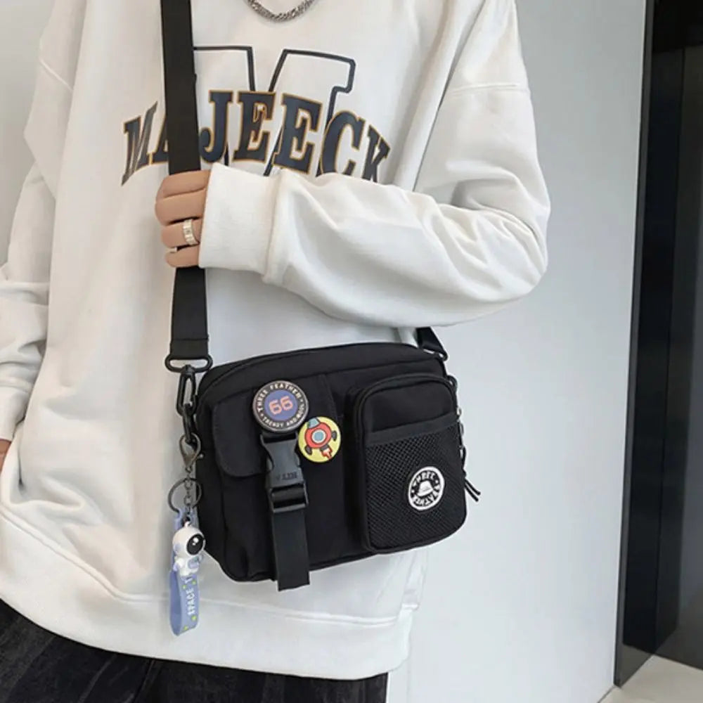 A woman wearing a white sweatshirt holds a black Quick-Dry Canvas shoulder bag.