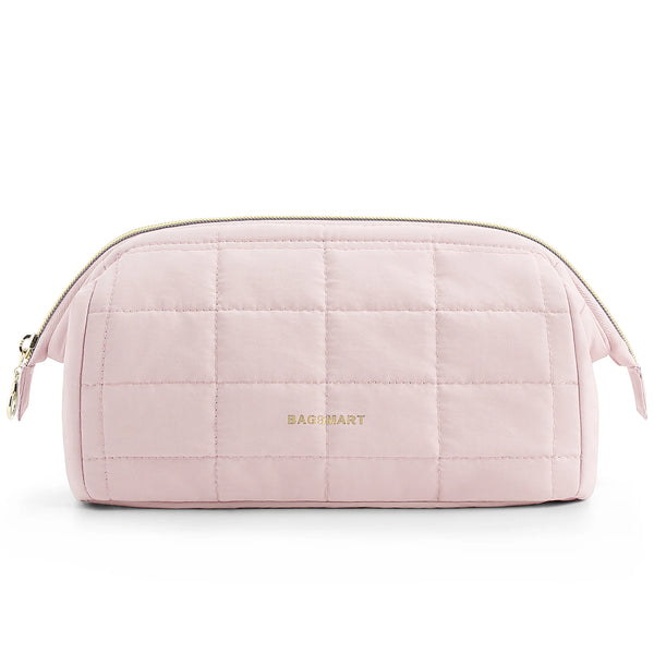 A light pink padded makeup bag with a quilted texture and gold lettering is shown flat.