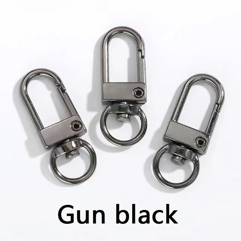 Drei silberne Metall-Swivel-Haken oder Karabiner, präsentiert vor weißem Hintergrund.