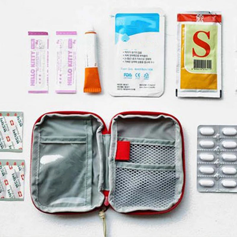A compact survival and first aid kit displayed with various components including a pouch, bandages, and a yellow packet.