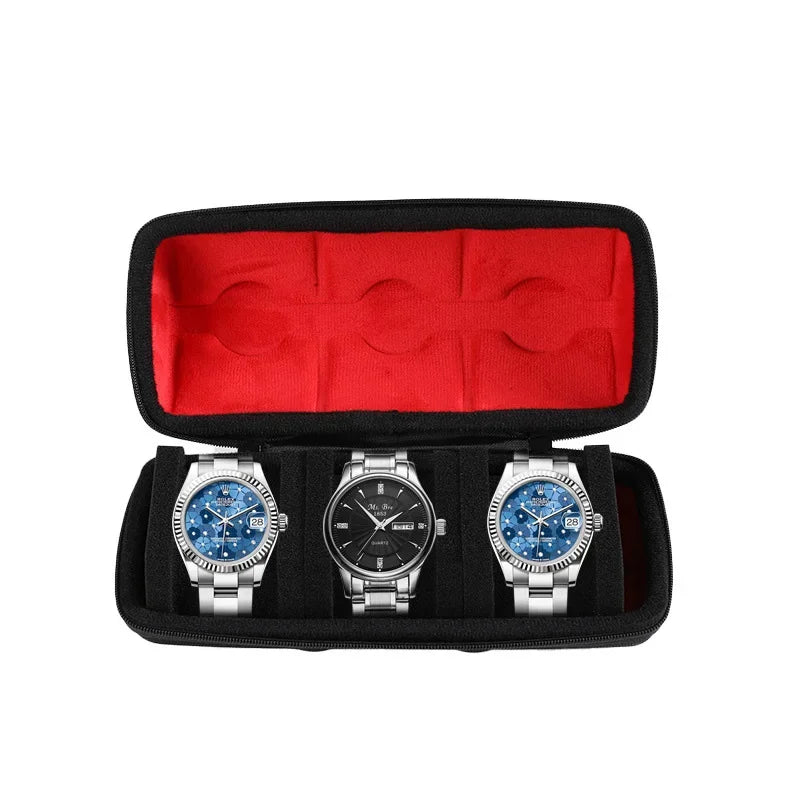 Black watch organizer case with red lining holding three silver-cased watches.