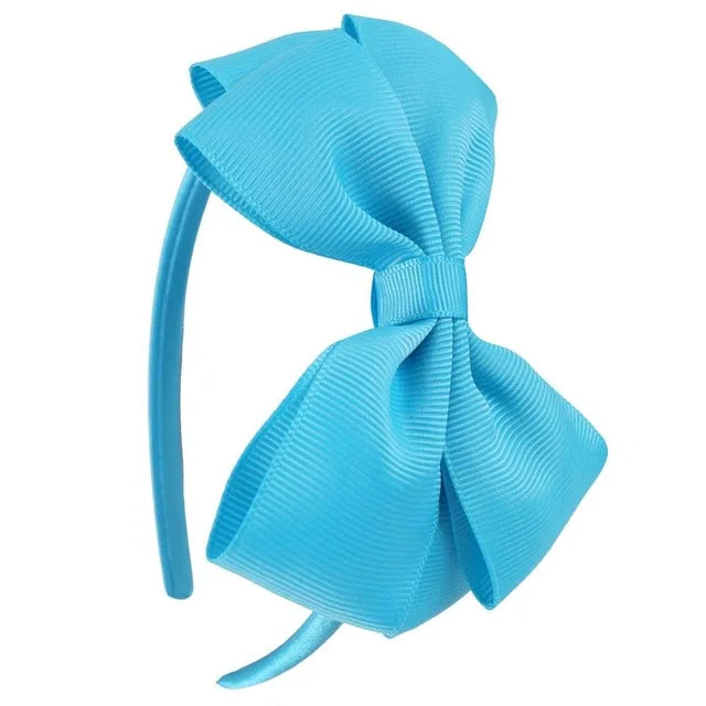 A close-up of a light blue satin bow headband.