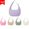 A set of four quilted nylon shoulder bags in pink, beige, sage green, and cream colors.