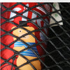 A close-up of a red container with a bear design covered in thickened elastic material, viewed through a black mesh net bag.