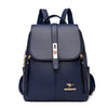 Sac à dos en cuir microfibre bleu marine avec accents dorés, vue de dos.