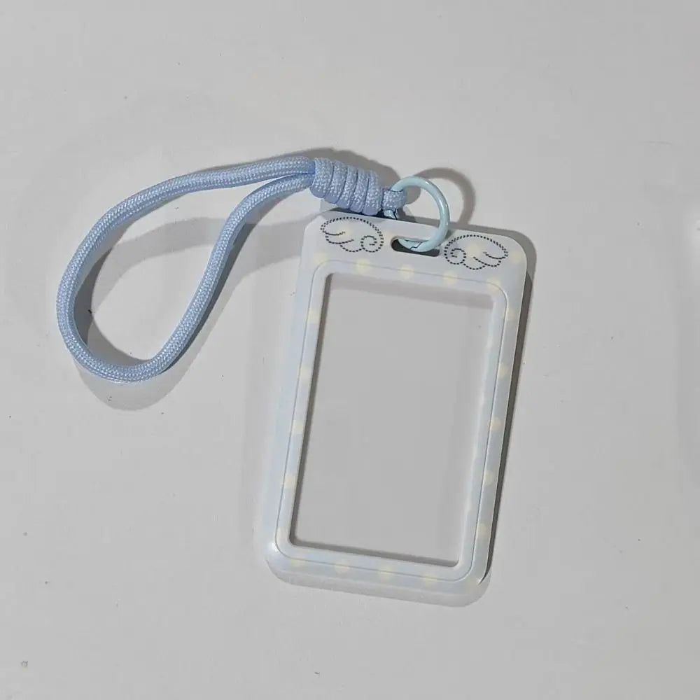 A light blue polka dot card holder with a lanyard is shown against a white background.