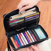 A black PU leather zipper wallet is shown open, displaying various credit cards and pens.