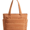 A tan quilted tote bag with a long handle is shown against a white background.