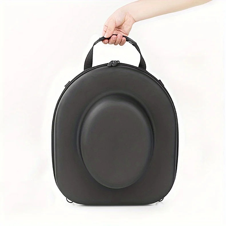 A hand is holding a black durable EVA hard shell hat case.