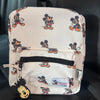 A beige backpack featuring Mickey Mouse print graphics on a light fabric.