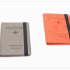 A pair of passport holders, one gray and one orange, made of premium PU leather.