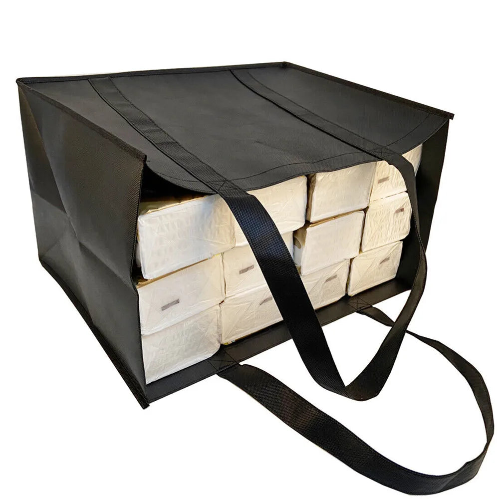 A black reusable tote bag filled with stacked white paper bags for grocery shopping.