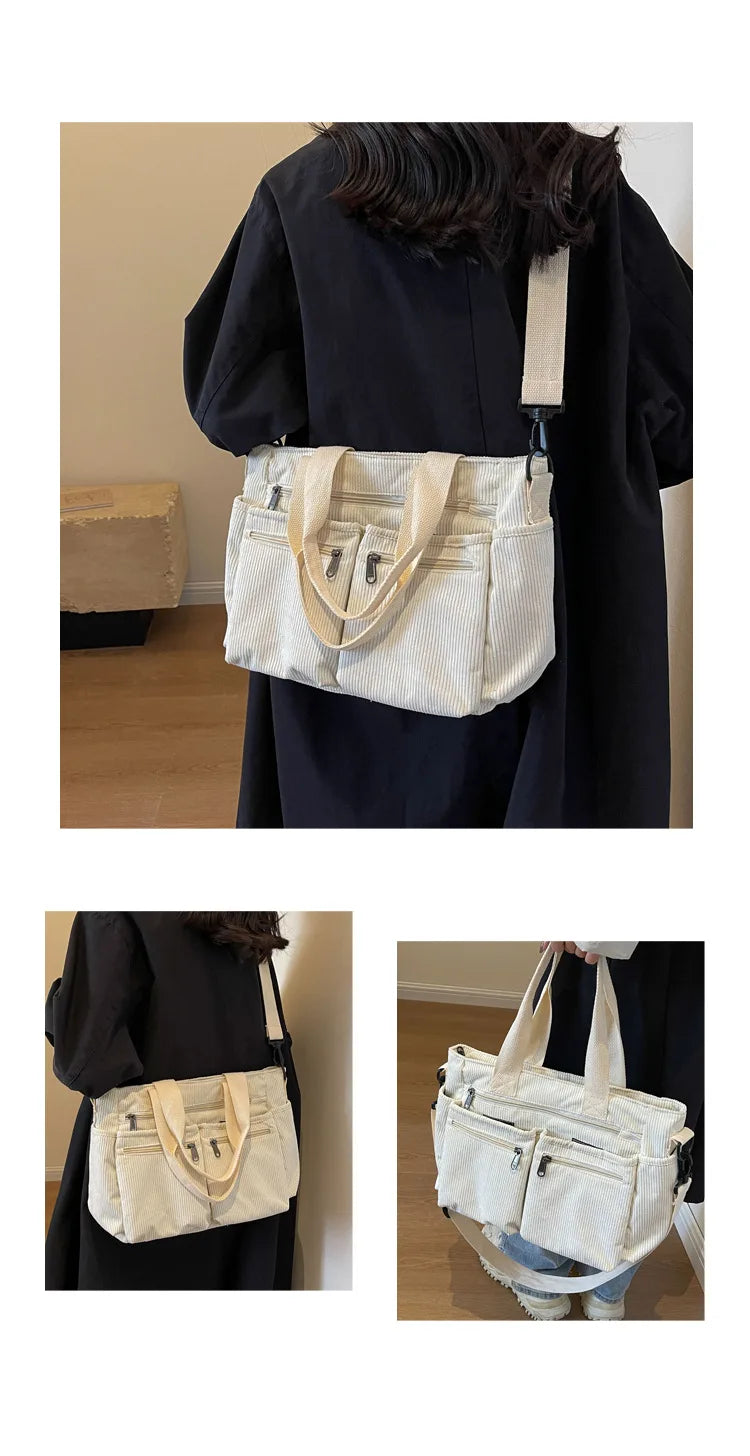 A beige striped corduroy tote bag with adjustable straps carried by a person in a black dress.