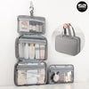 A gray travel toiletry bag with a hanging hook, open to show various skincare and grooming products.