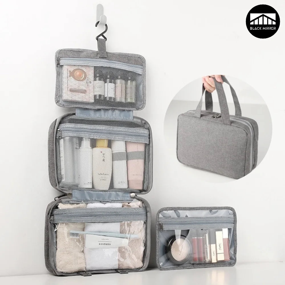 A gray travel toiletry bag with a hanging hook, open to show various skincare and grooming products.