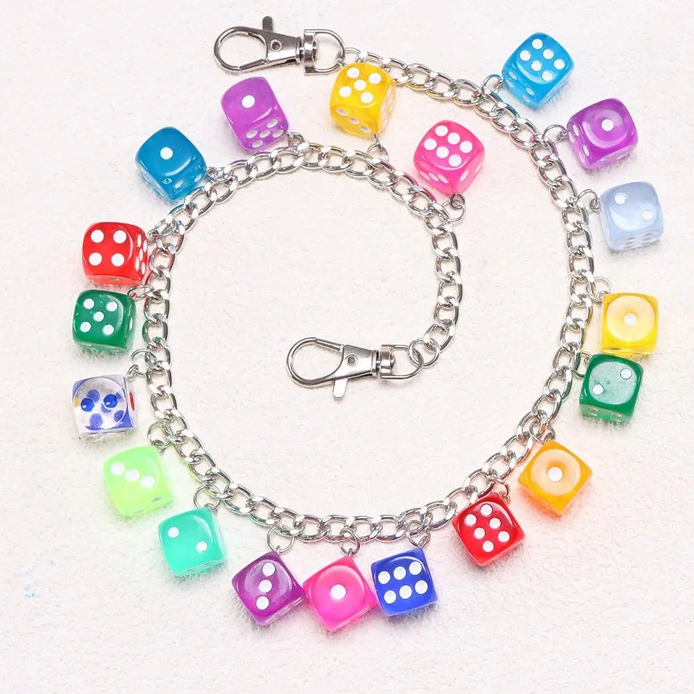 A silver chain necklace featuring colorful plastic dice in various shades of blue, green, pink, and yellow.