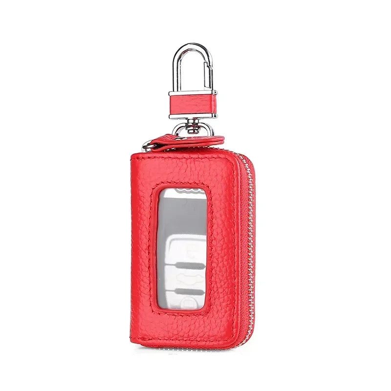 A red leather car key case with a transparent window and a silver padlock hook.