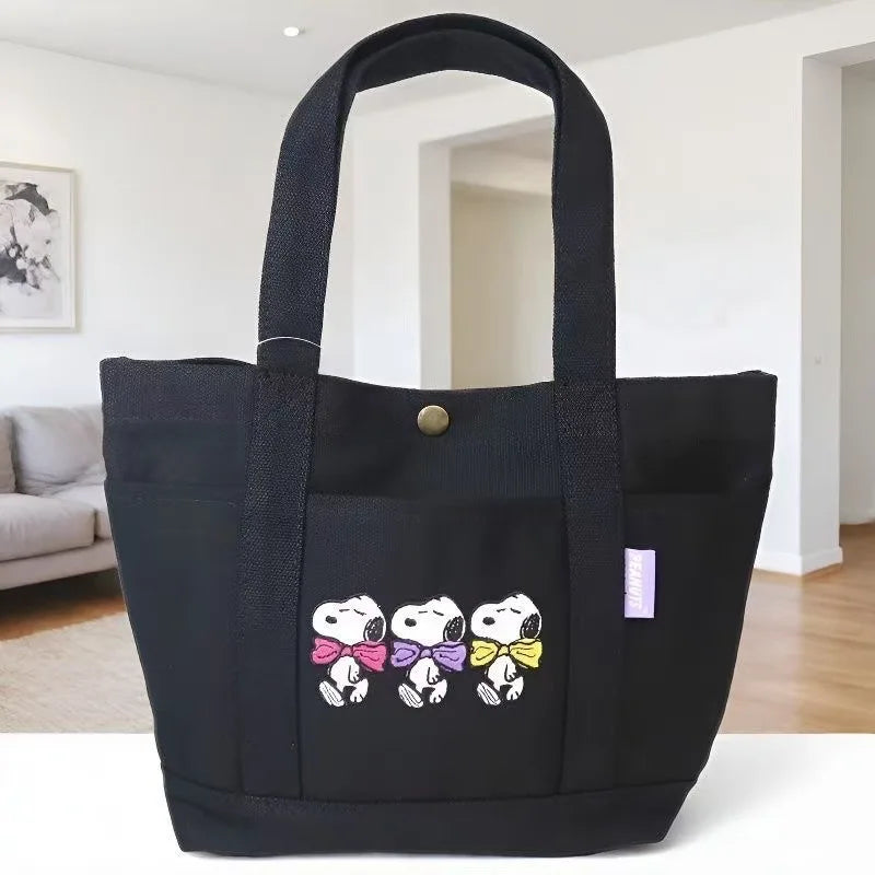 Black canvas shoulder bag featuring a Snoopy cartoon design for women
