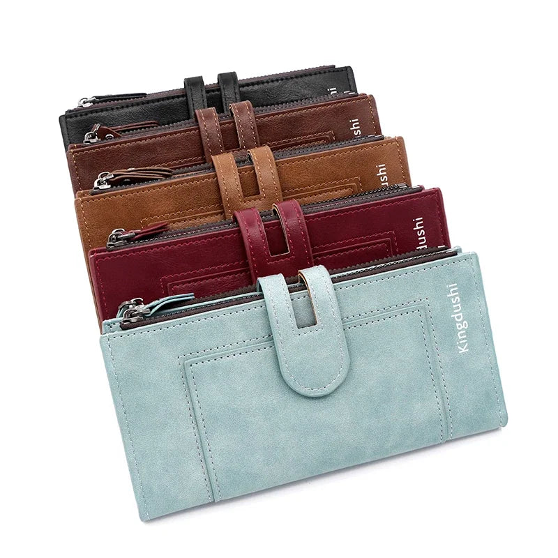 A stack of brown, burgundy, and light blue leather wallets and card holders.
