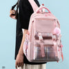 A pink canvas backpack with a plaid pattern is worn by a person.
