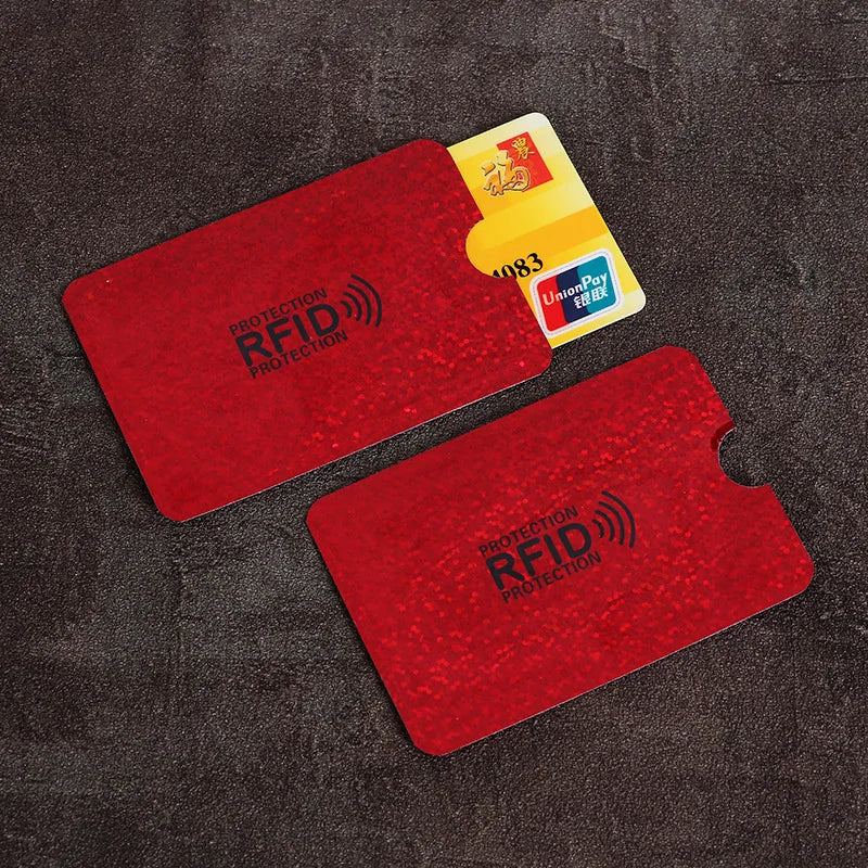 Two red anti-scan RFID protection cards are shown on a dark surface with a yellow UnionPay card nearby.