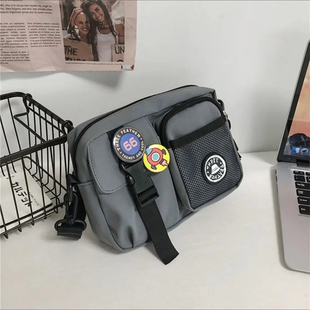 A gray quick-dry canvas shoulder bag with a black strap and a yellow circular tag is displayed on a white surface.