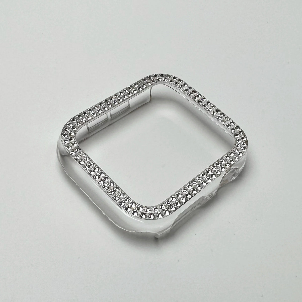 Clear silicone bumper case for an Apple Watch decorated with small glitter diamonds and rhinestones