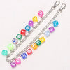 A silver chain featuring colorful dice charms, including pink, yellow, blue, and green varieties.
