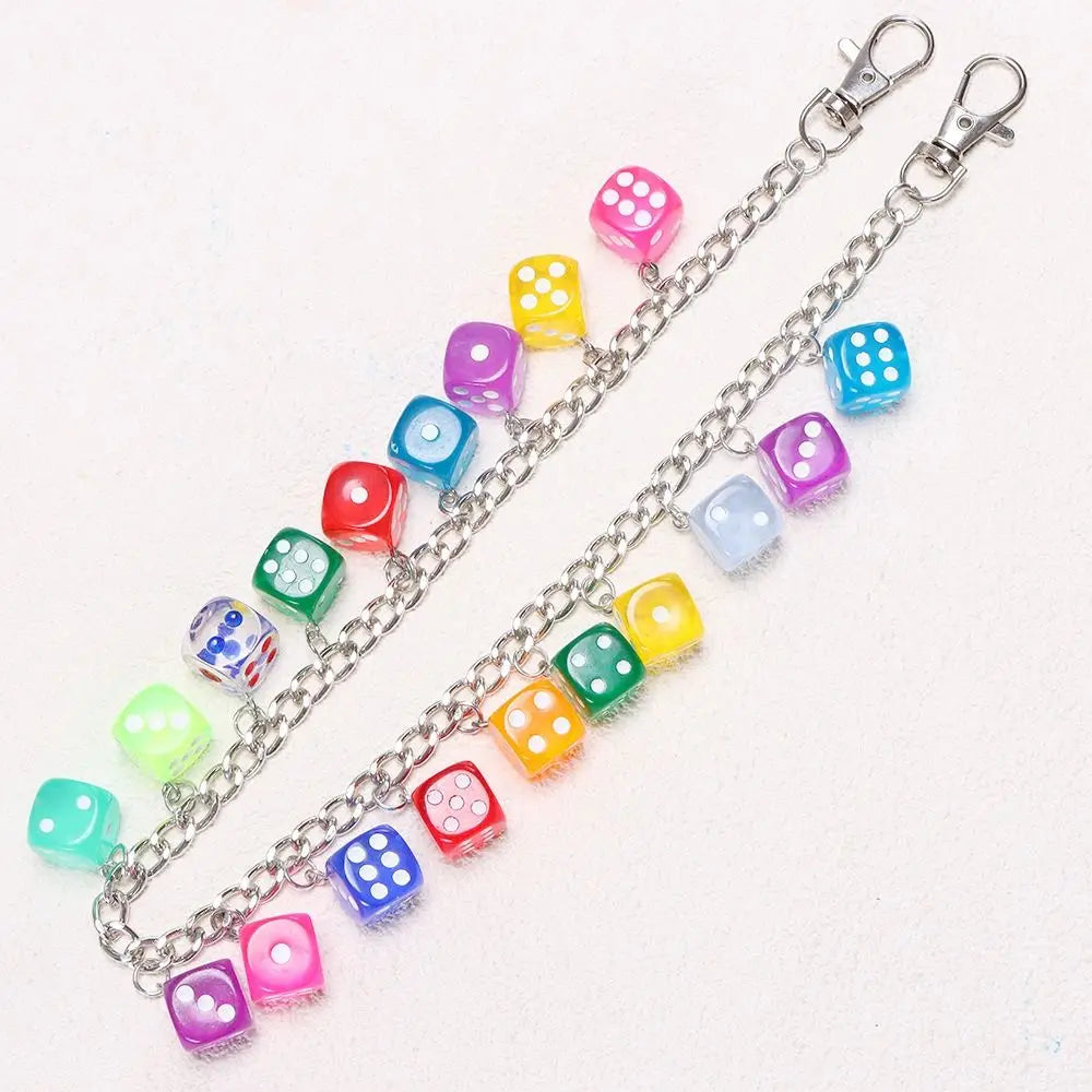A silver chain featuring colorful dice charms, including pink, yellow, blue, and green varieties.